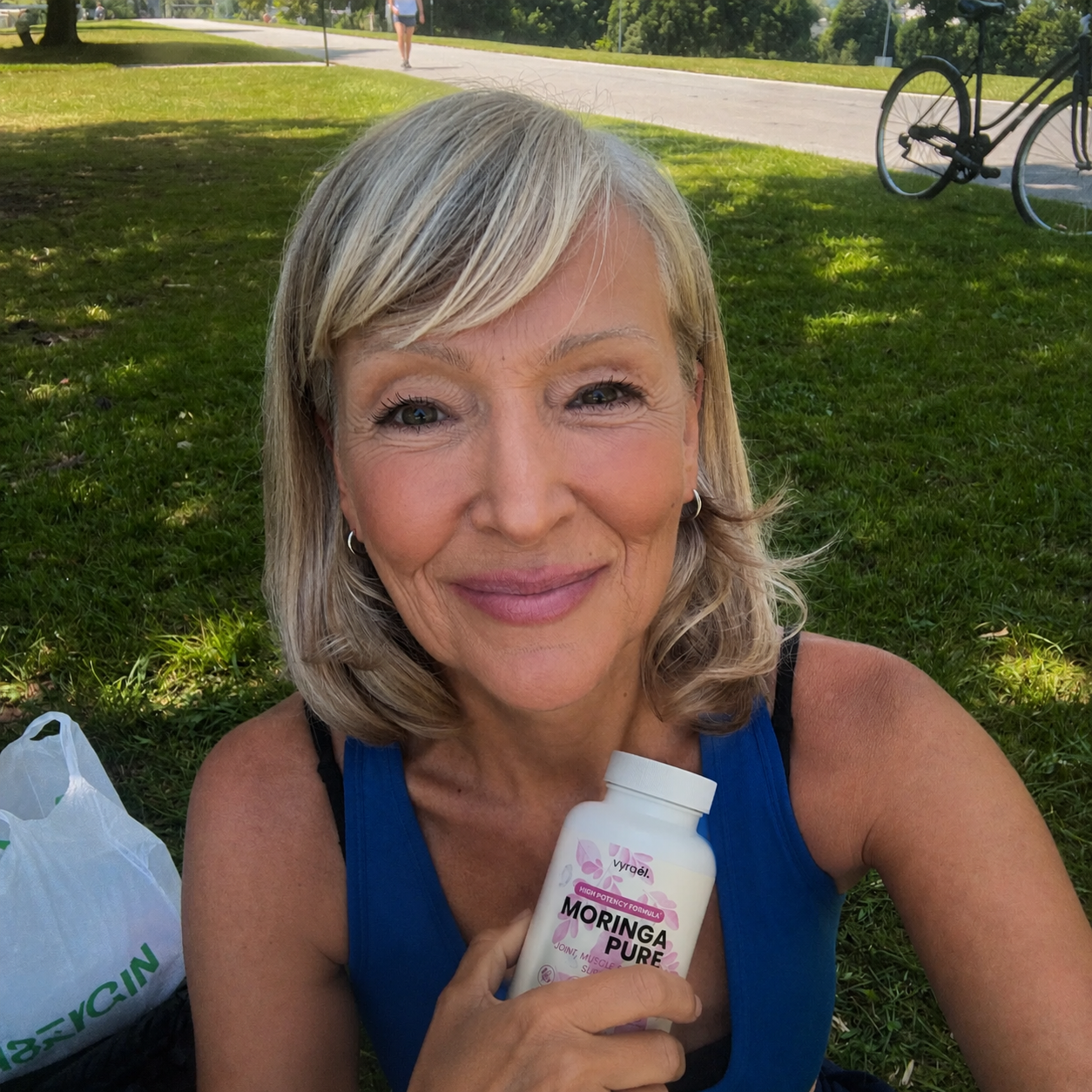 Woman holding Moringa Pure